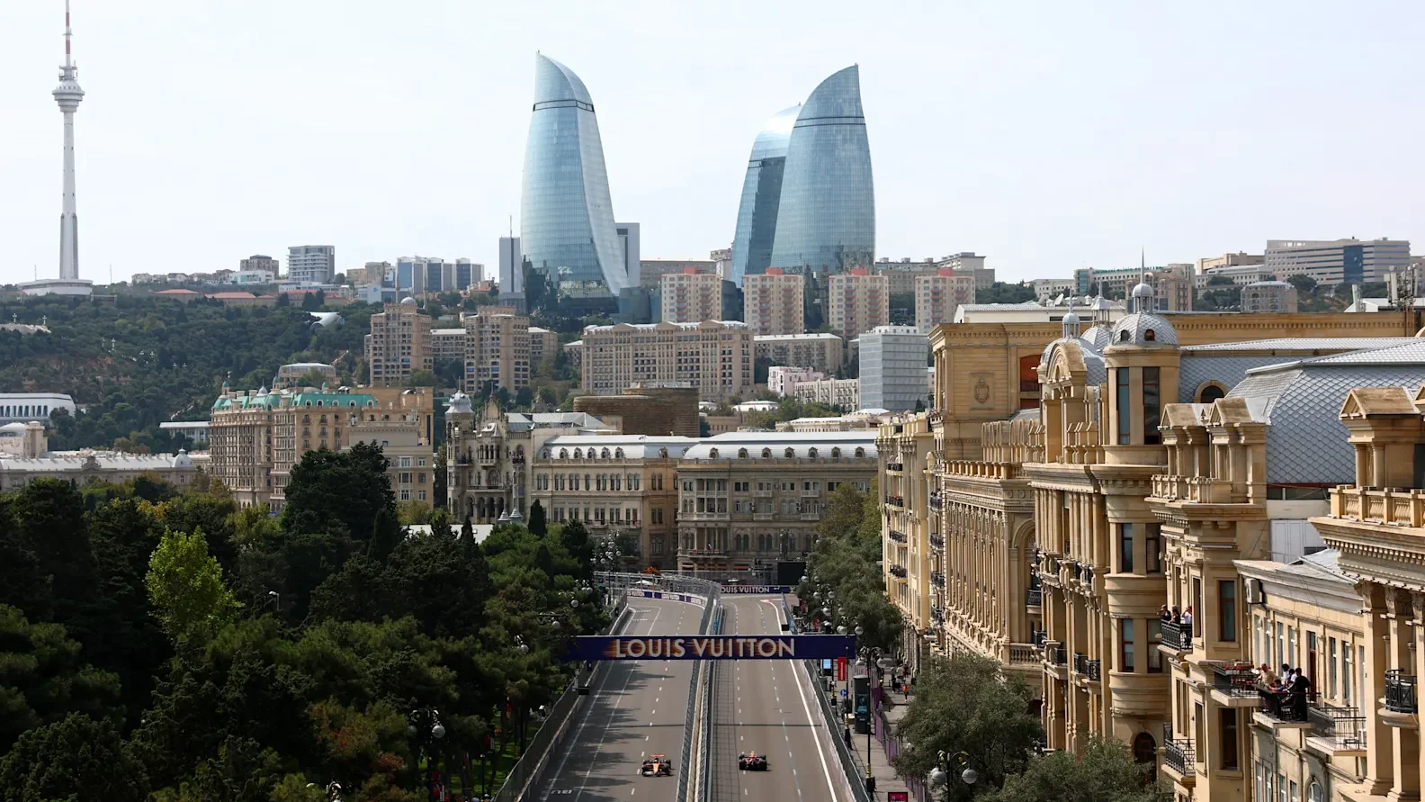 Formula 1 cars racing through central Baku below the Flame Towers