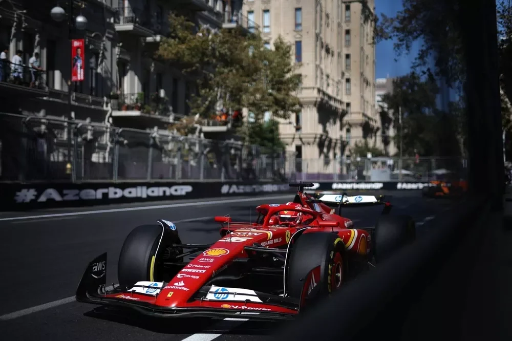 Charles Leclerc driving a Ferrari between the close barriers of Baku City Circuit