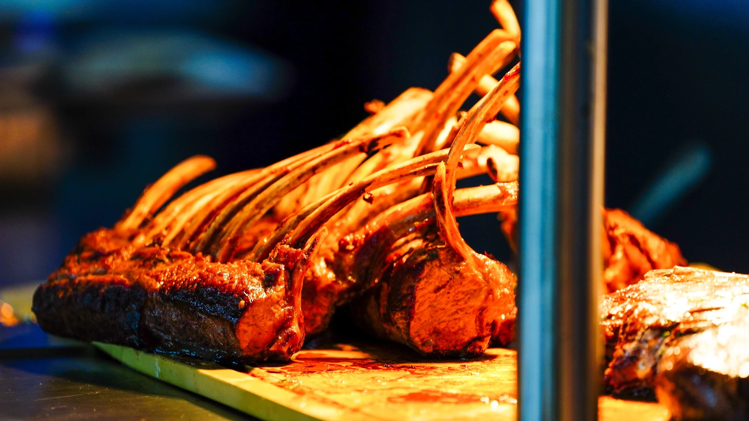 Catered roasted meat being served in a United States Grand Prix hospitality dining area