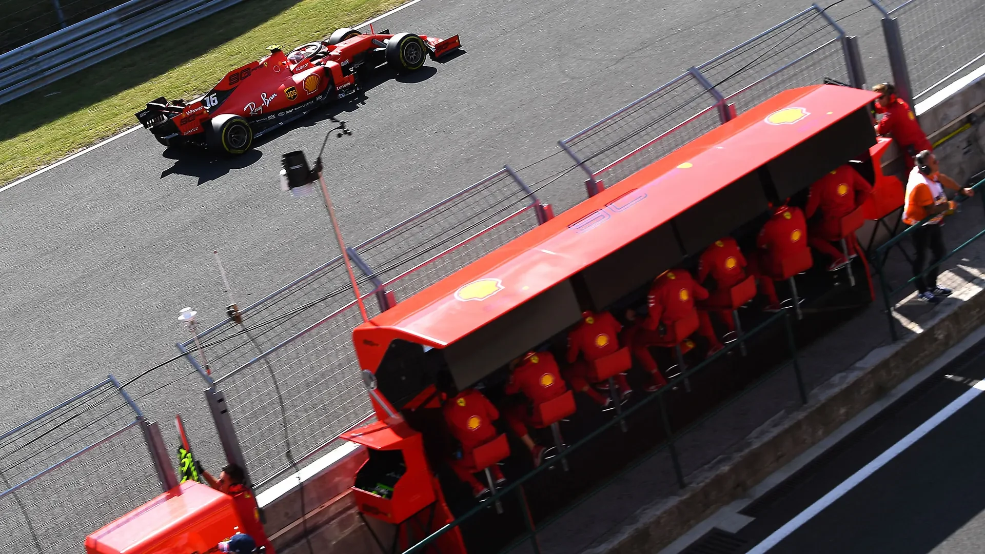 Ferrari Formula 1 pit wall overlooking two cars on track
