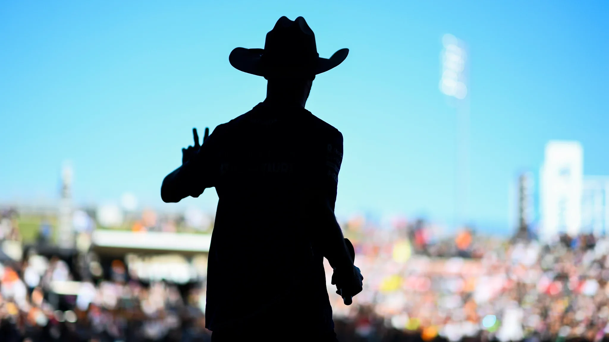 Cowboy-hatted figure overlooking a Formula 1 crowd at Circuit of The Americas
