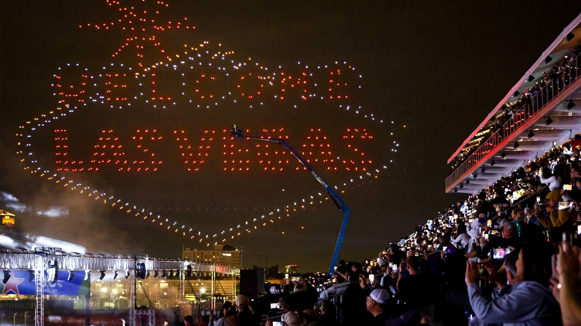 Las Vegas Grand Prix spectators watching a drone display from a grandstand