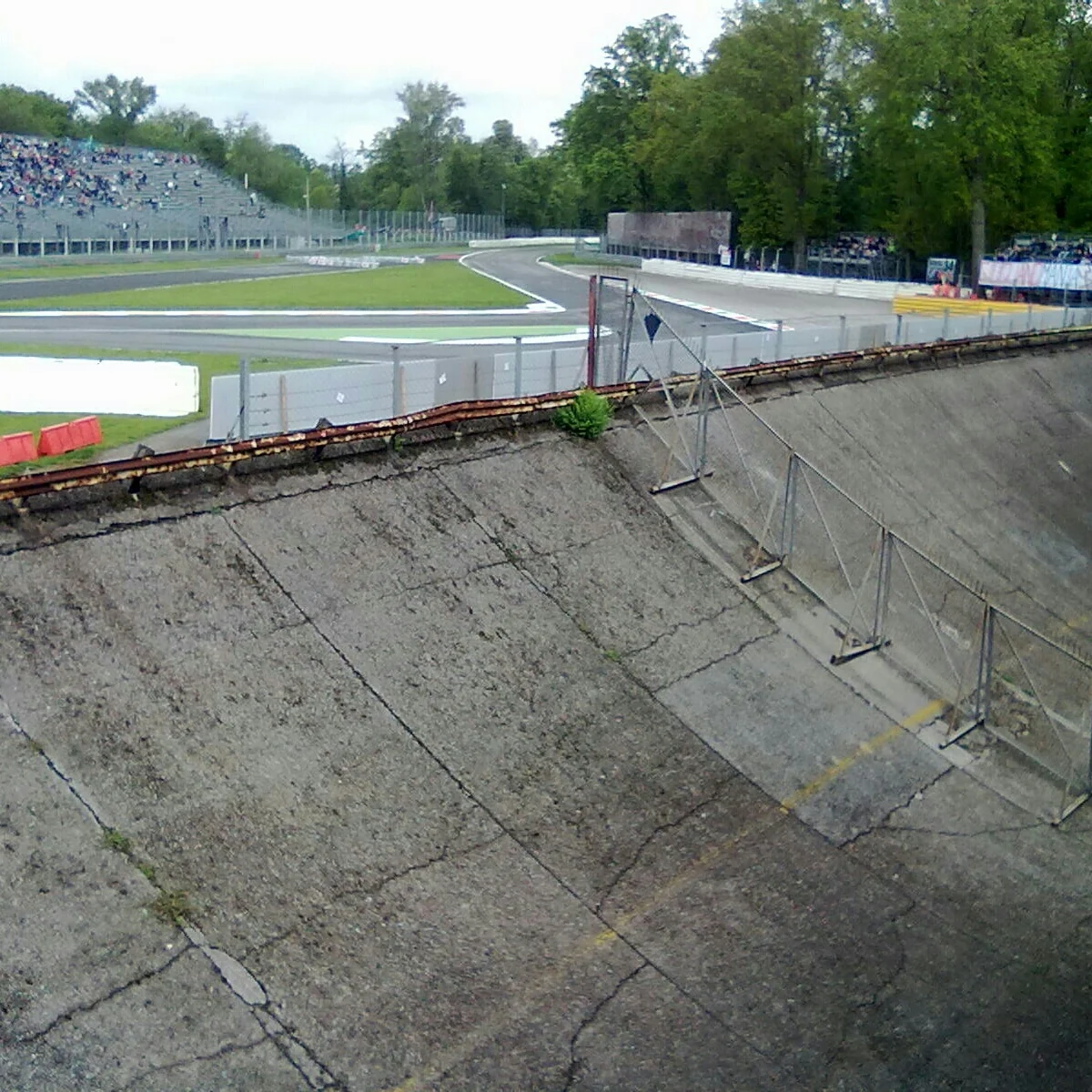 Trackside view near the first corner with Monza's historic oval structure visible
